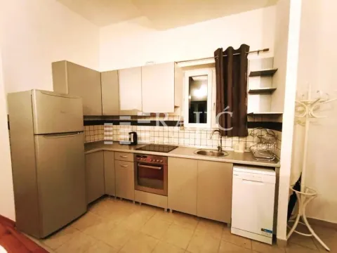 Small equipped kitchen with white goods and cabinets. - image 4