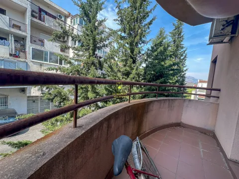 Prostrana polukružna terasa sa pogledom na susjedne zgrade i drveće. - image 19