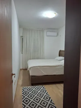View from the hallway into a furnished bedroom with a double bed. - image 5