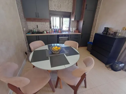 Modern kitchen with a dining table and chairs. - image 4