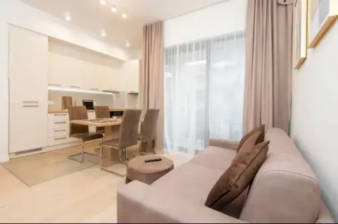 Living room with a sofa set and a dining area combined with the kitchen. - image 11