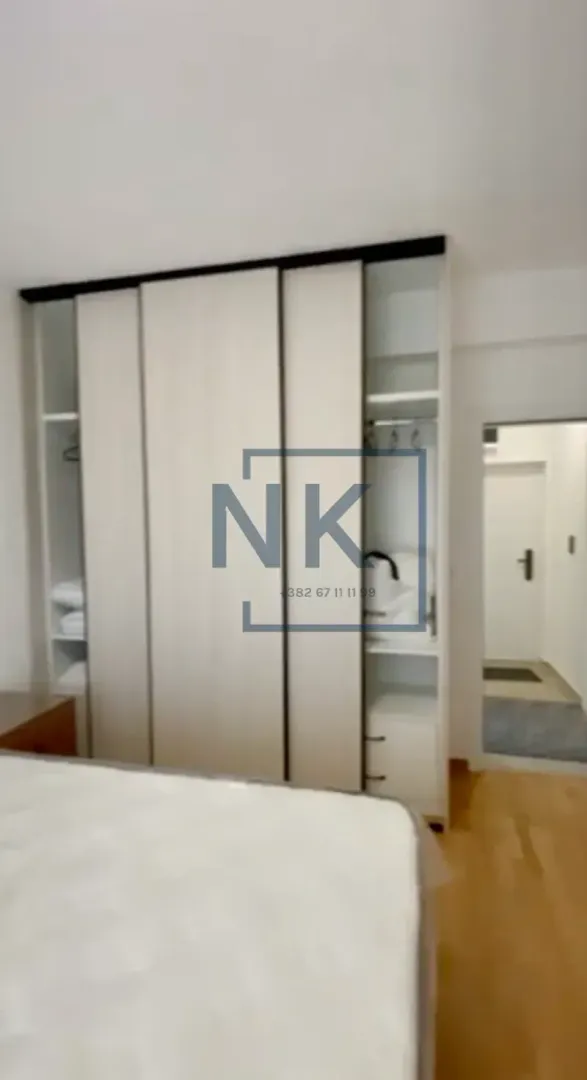 Bedroom with a large built-in wardrobe and a bed.