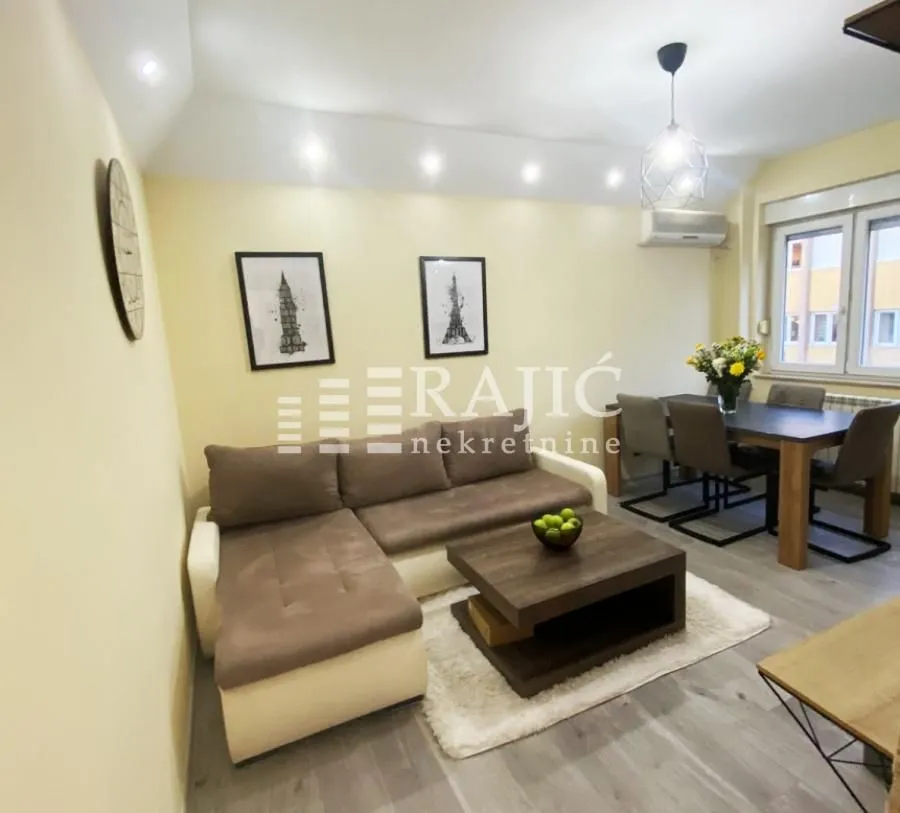 Living room with a sofa and dining area.