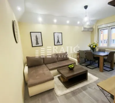 Living room with a sofa and dining area. - image 2