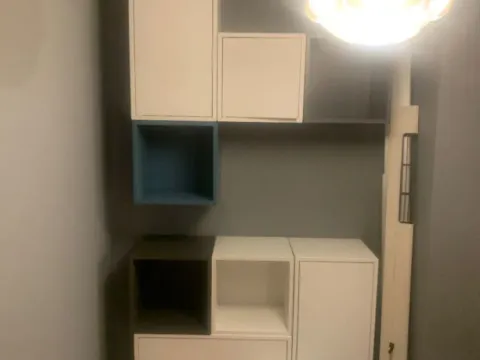 Small space with built-in storage units and a hanging lamp. - image 2
