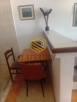 Small dining table with chairs in the living room. - image 3
