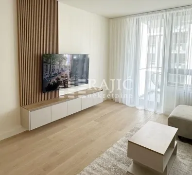 Living room with a wooden wall panel, TV, and media console. - image 2