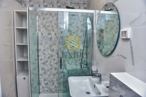 Modernly equipped bathroom with a shower cabin and washbasin. - image 7