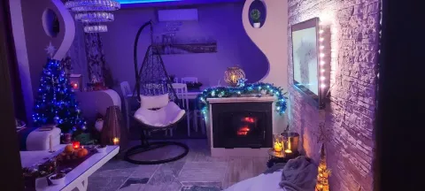 Living room with a fireplace and holiday decoration. - image 3