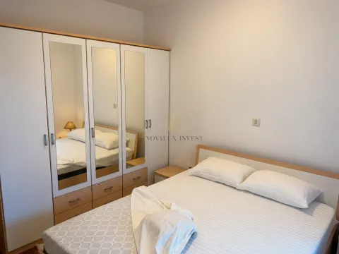 Furnished bedroom with a double bed and a large wardrobe with mirrored doors. - image 6