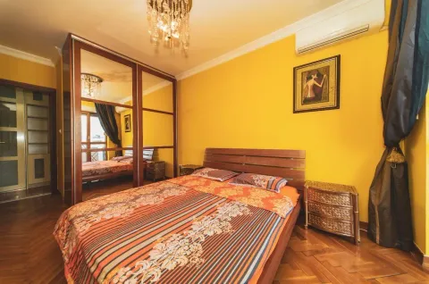 Furnished bedroom with a double bed, large mirrored wardrobe, and yellow walls. - image 12