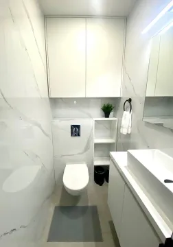 Modernly equipped bathroom with white ceramic tiles and built-in sanitary ware. - image 14