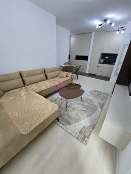 Living room with sofa, coffee table and a view towards the kitchen and dining area. - image 2