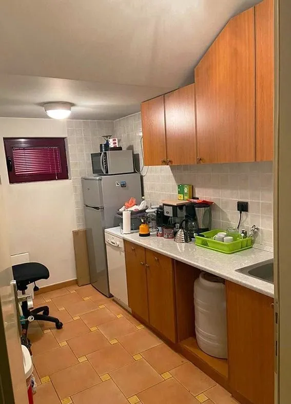 Small kitchen with wooden cabinets and appliances.