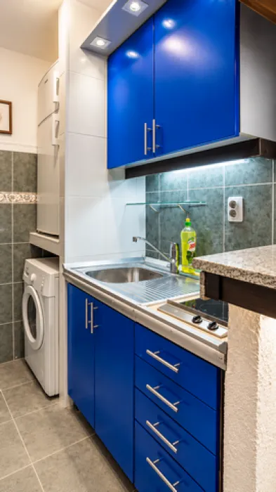 Kitchen with blue cabinets and built-in appliances.