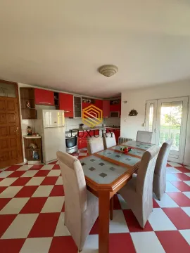 Spacious kitchen with a dining area and red-and-white ceramic floor tiles. - image 14