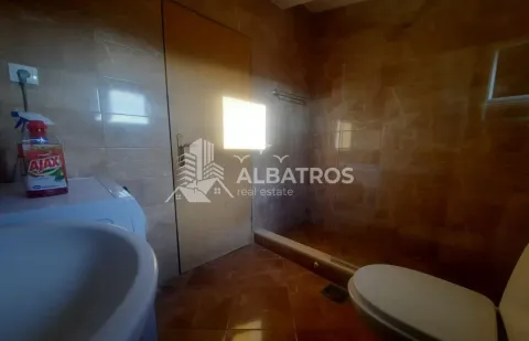 Bathroom lined with ceramic tiles and a walk-in shower. - image 12