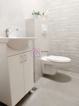 Modern bathroom with a washbasin, cabinet, and wall-mounted toilet. - image 8