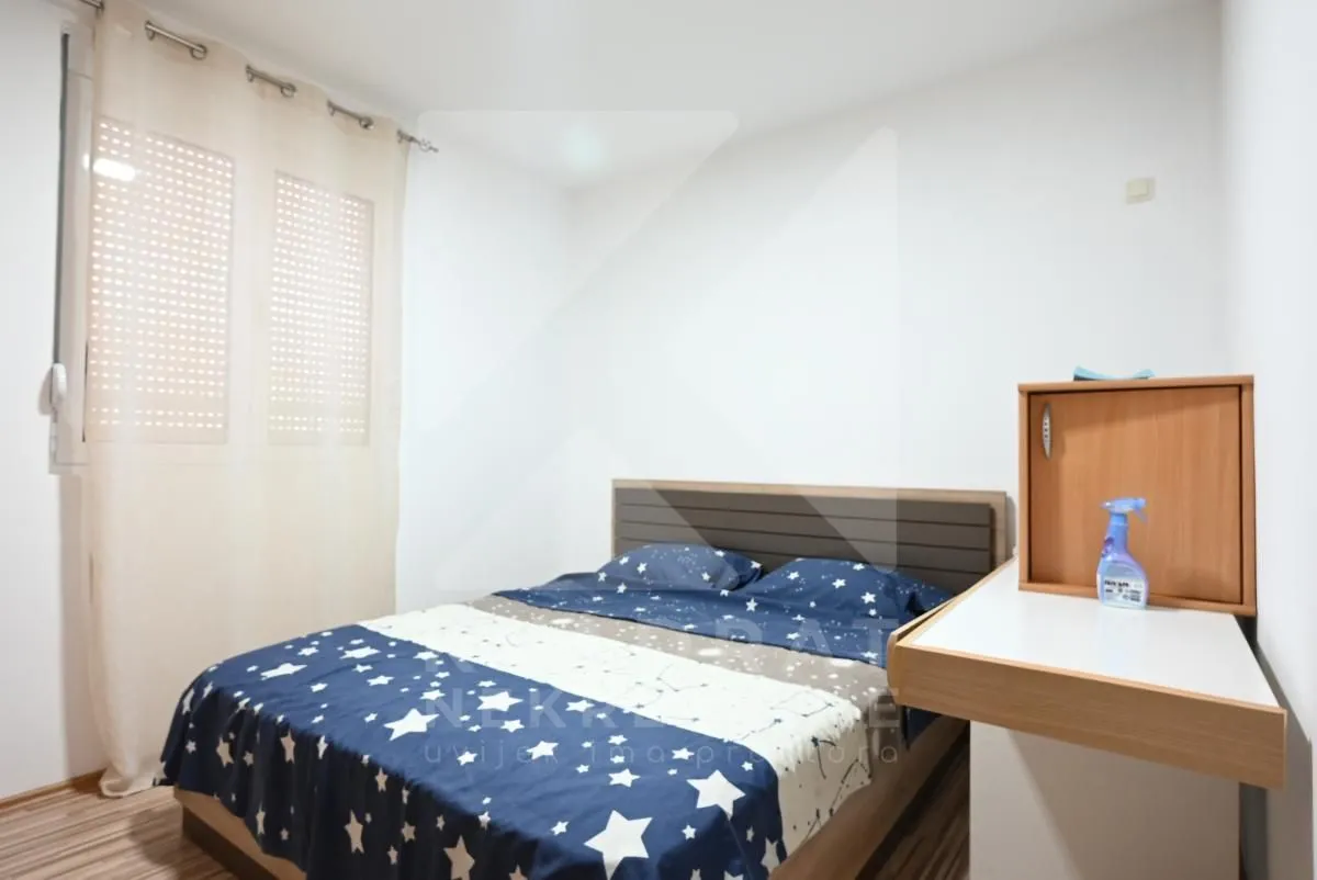Bedroom with a double bed and a window.