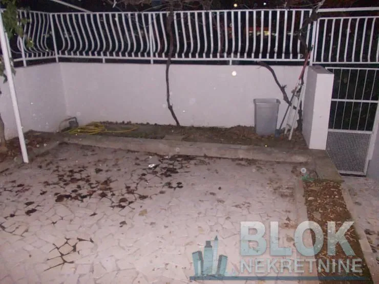 Paved yard with a fence and a gate.