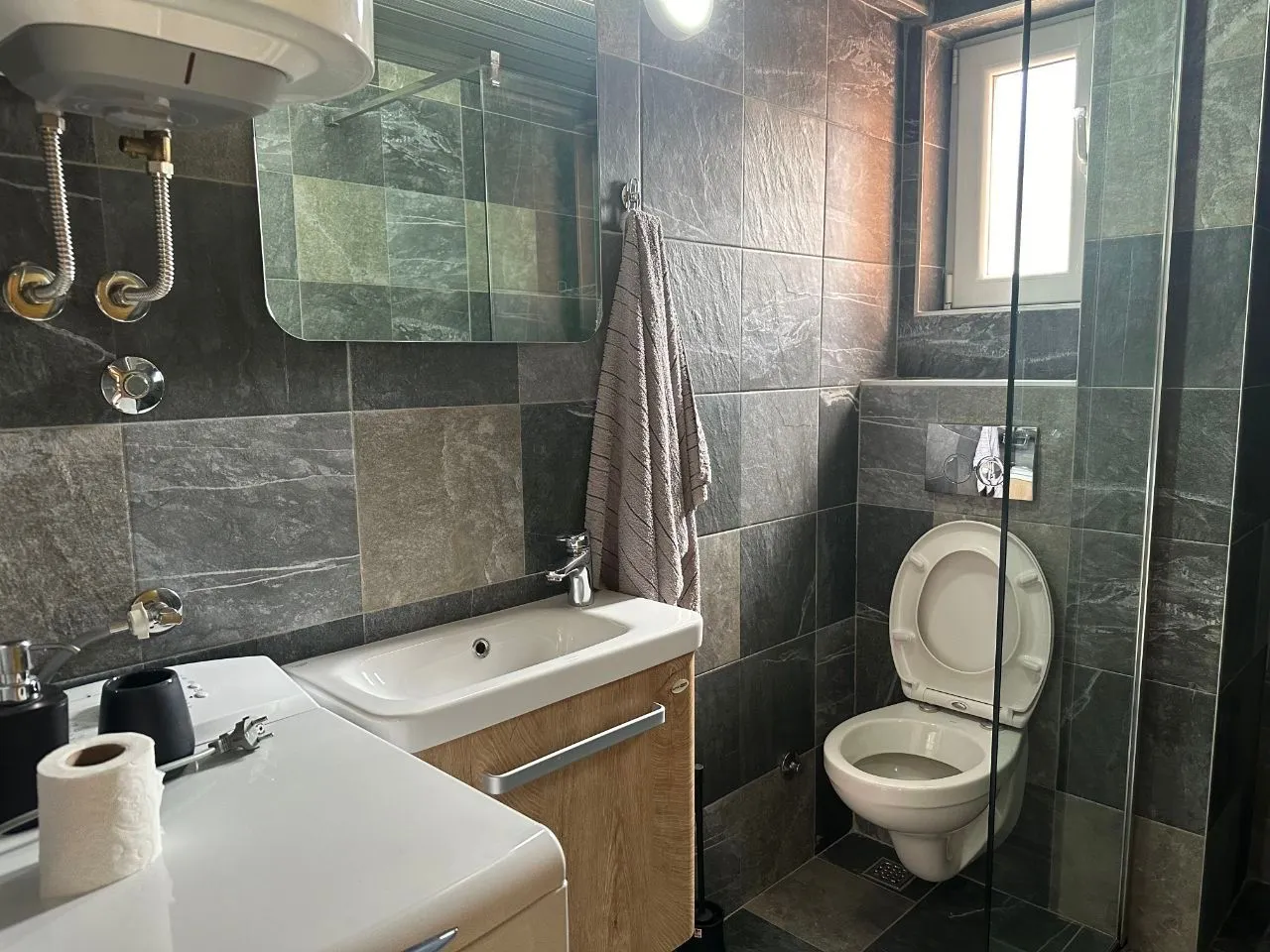 Modern bathroom equipped with a walk-in shower and vanity unit.