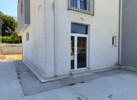 Exterior of the house with an entrance door and yard. - image 3