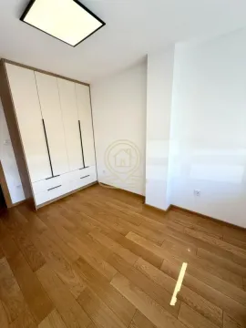 Bedroom with built-in wardrobe and hardwood flooring. - image 5
