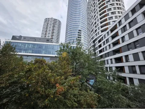 View of modern residential buildings and surrounding greenery. - image 9