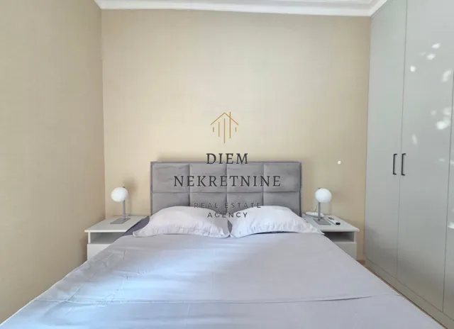 Furnished bedroom with a double bed, wardrobe, and nightstands.