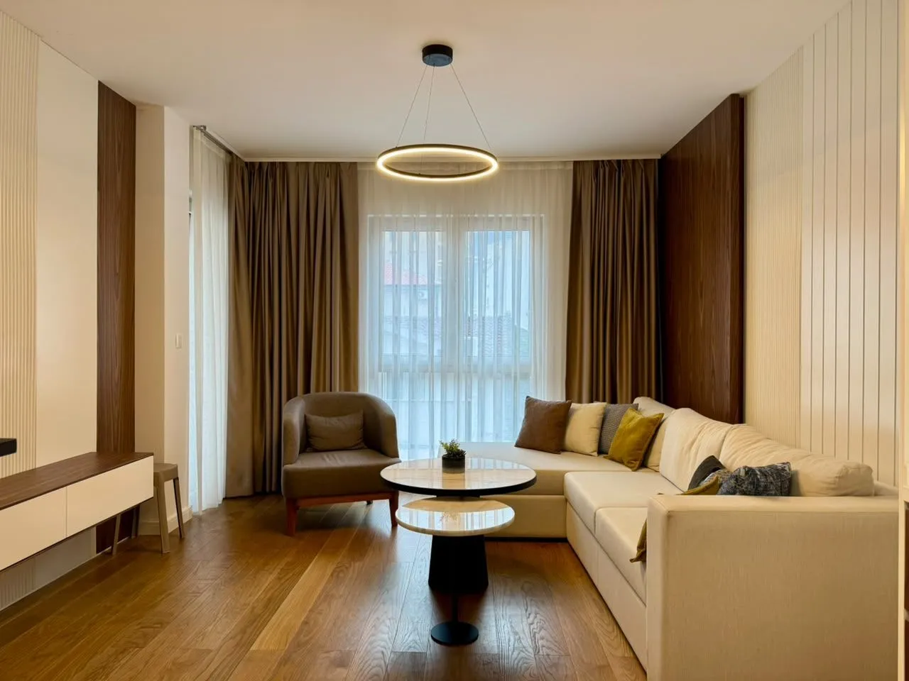 Modern and bright living room with a sofa, armchair and coffee table.