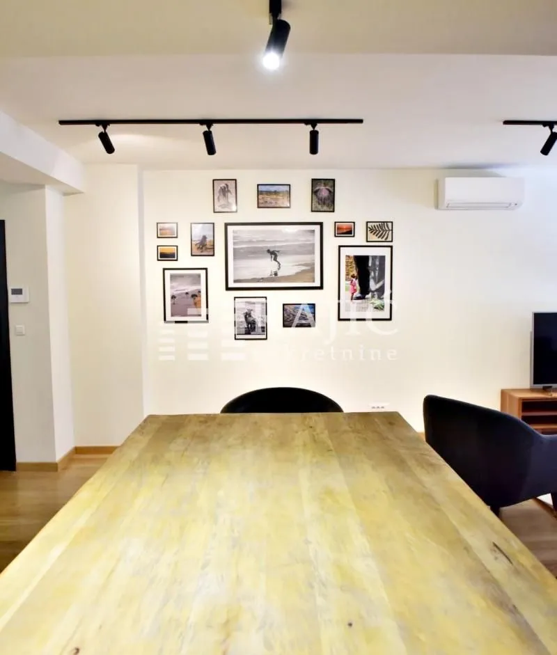 Living room with a dining table and decorative pictures on the wall.