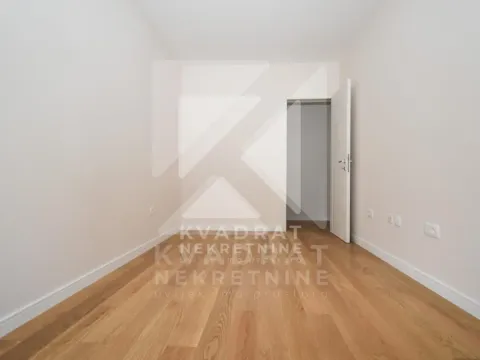 Empty room with wooden flooring and an open door. - image 5