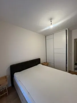 Simple bedroom featuring a double bed and a sliding wardrobe. - image 2