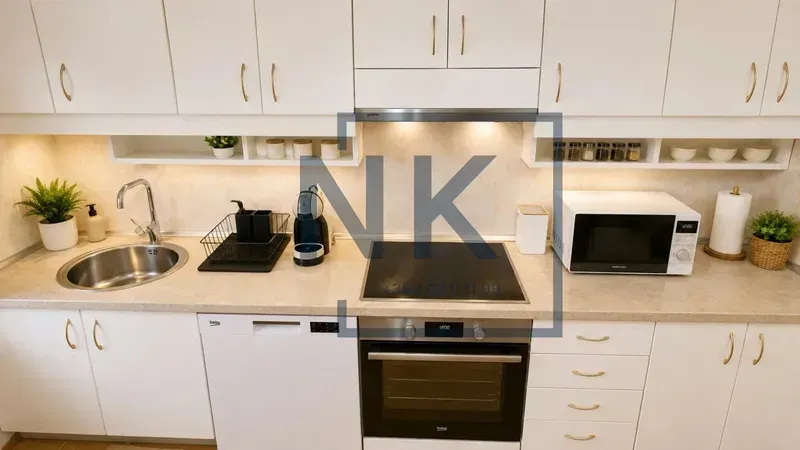 White kitchen with a sink, built-in oven, stovetop, and appliances.