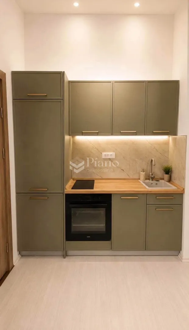 Small kitchen with green cabinets and a built-in oven.