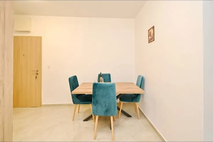 Dining area with a wooden table and blue chairs.