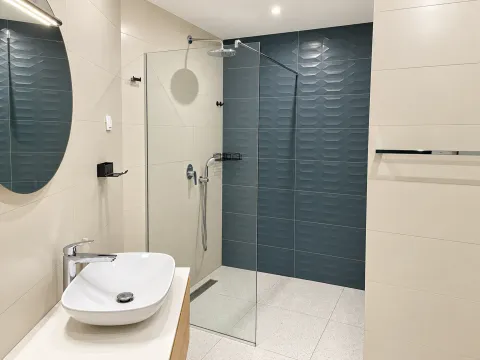 Modern bathroom with a sink and a walk-in shower. - image 15