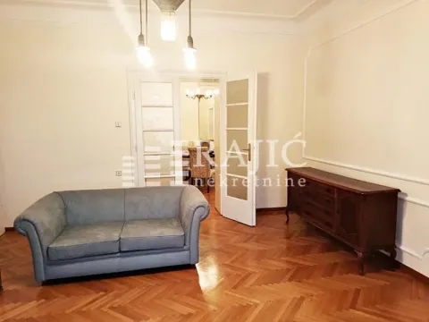 Spacious living room with seating furniture and a view into the dining area. - image 13