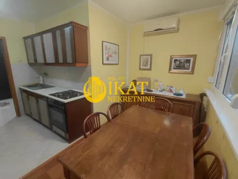 Kitchen with dining area and wooden furniture. - image 10