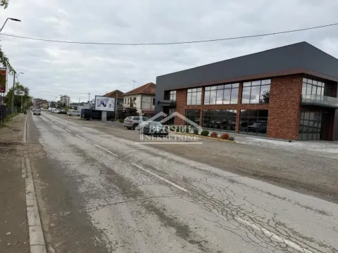 View of the exterior of a commercial building with parking next to the street. - image 3