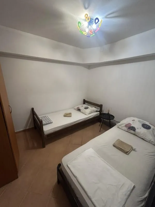 Bedroom with two single beds and a wardrobe.