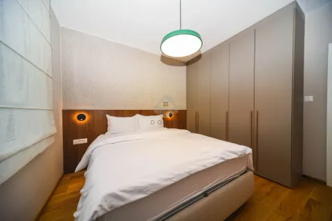 Modern bedroom with a double bed, built-in wardrobe, and wooden wall paneling. - image 9