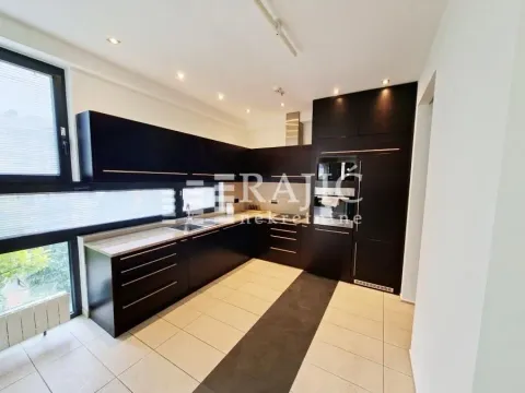 Modern kitchen with dark cabinets and built-in appliances. - image 5