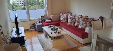 Living room with a sofa, coffee table, and TV. - image 2