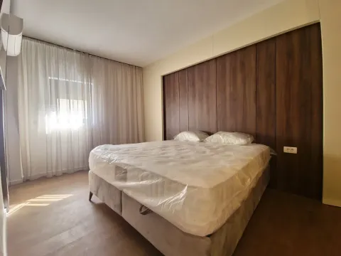 Bedroom with a double bed and wooden wall paneling. - image 8