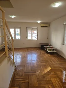 Empty living room with parquet flooring and stairs leading to the upper floor. - image 15