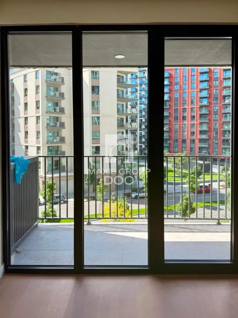 View from the balcony towards neighboring residential buildings and the street.