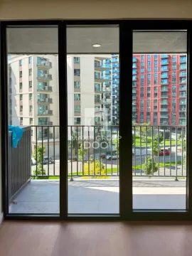 View from the balcony towards neighboring residential buildings and the street. - image 10