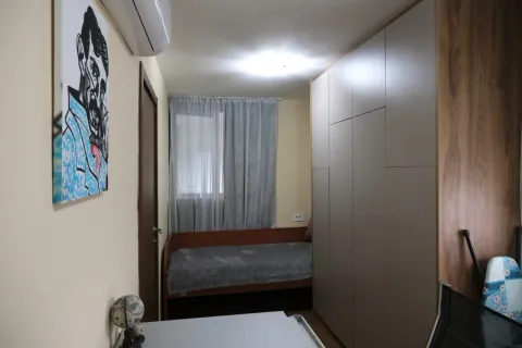 Simple bedroom with a bed and wardrobe. - image 17