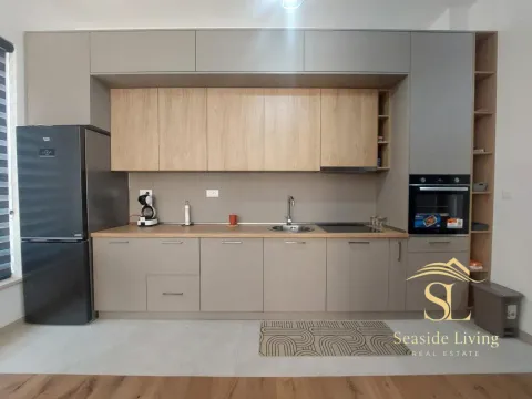 Modern kitchen with grey cabinets and wooden accents. - image 6